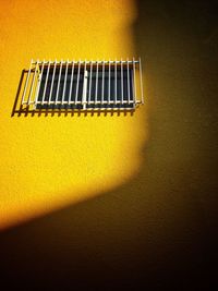 Low angle view of yellow window on wall