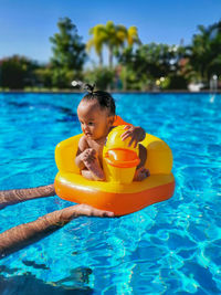 Full length of baby girl in swimming pool