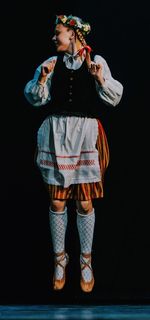 Full length of boy standing against black background