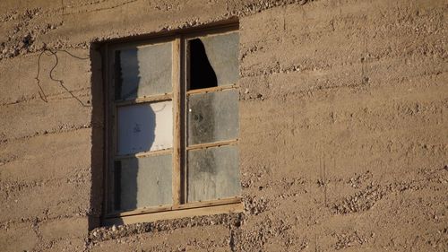 Low angle view of window on concrete wall