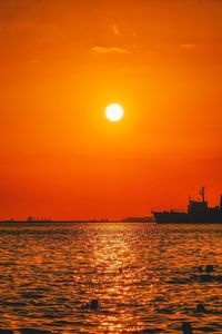 Scenic view of sea against orange sky