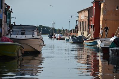 Boats moored at harbor in city