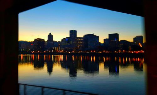 River with buildings in background at sunset