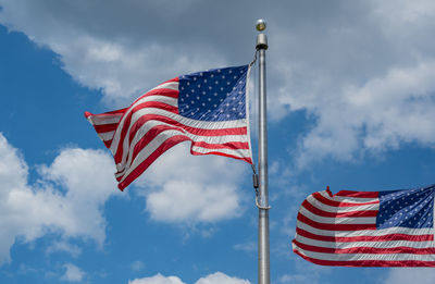Low angle view of american flag against sky