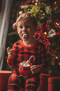 Portrait of cute girl blowing christmas tree