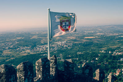View of flag on landscape against clear sky