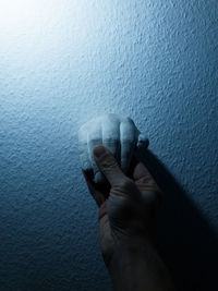 Close-up of hand on wall