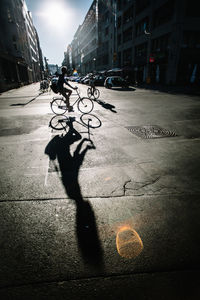 Shadow of man on street in city