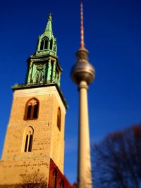 Low angle view of tower against blue sky