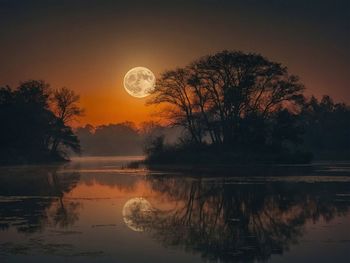 Scenic view of lake against sky during sunset