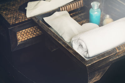 High angle view of towel and beauty products on table