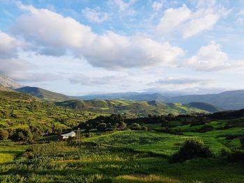 Scenic view of landscape against cloudy sky