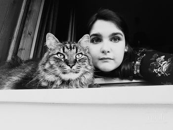 Portrait of young woman with cat
