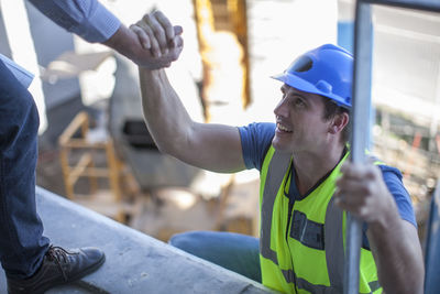 Construction worker shaking hands on construction site