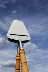 Low angle view of electric lamp against blue sky