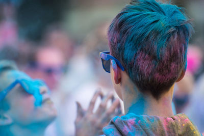 Rear view of boy covered with powder paint