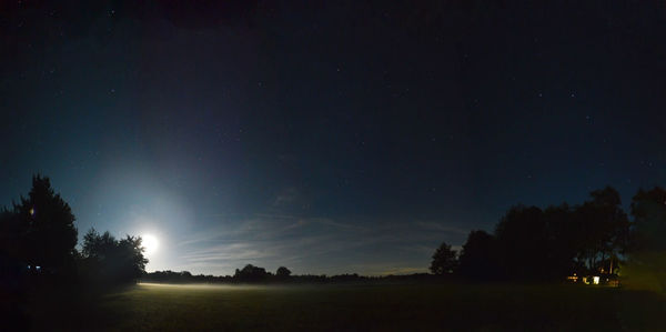 Scenic view of field against starry sky with full moom