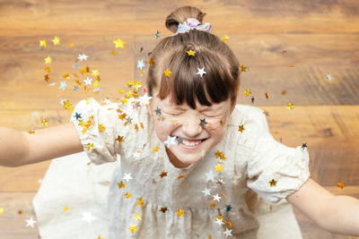 Portrait of a pretty girl with star-shaped sequins on her face.the girl smiles.fun holiday,party 