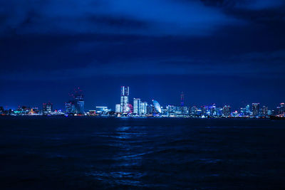 Boats in sea against sky at night