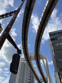 Low angle view of buildings against cloudy sky