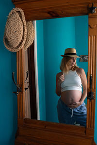 Rear view of woman looking through window