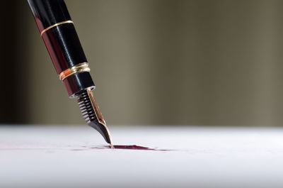 Close up of fountain pen on red ink