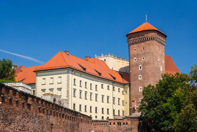 Low angle view of buildings against blue sky