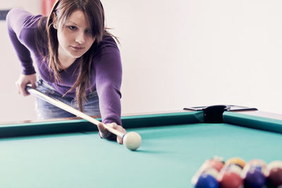 Beautiful woman playing pool