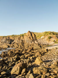 Rock formations on landscape against clear sky