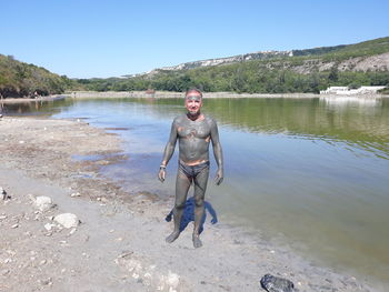 Woman in lake against clear sky