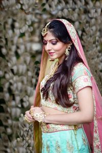 Beautiful woman in sari standing on land during wedding