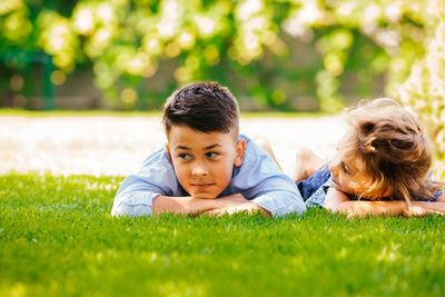 Portrait of friends lying on grass