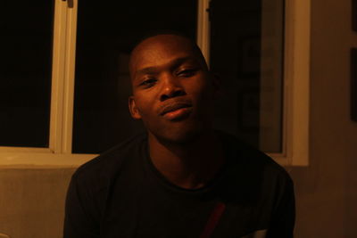 Portrait of young man looking away at home