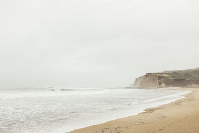 Scenic view of beach against clear sky