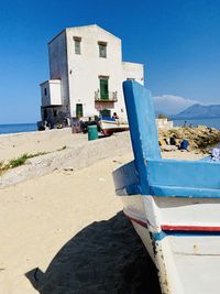 View of beach against clear blue sky