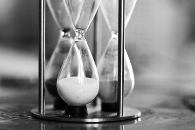 Close-up of clock on glass table