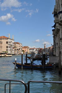 View of boats in city against sky