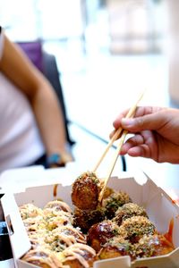 Midsection of woman holding food on table