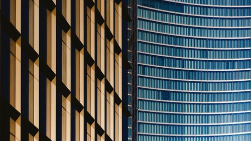 Low angle view of modern glass building in city