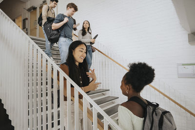 Multiracial students on steps in university