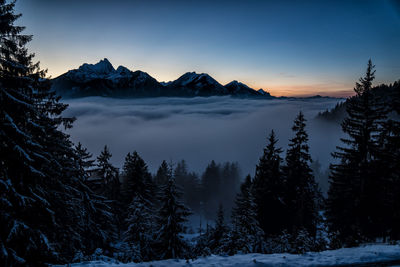 Scenic view of snowcapped mountains against sky during winter