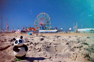 Toy panda at beach