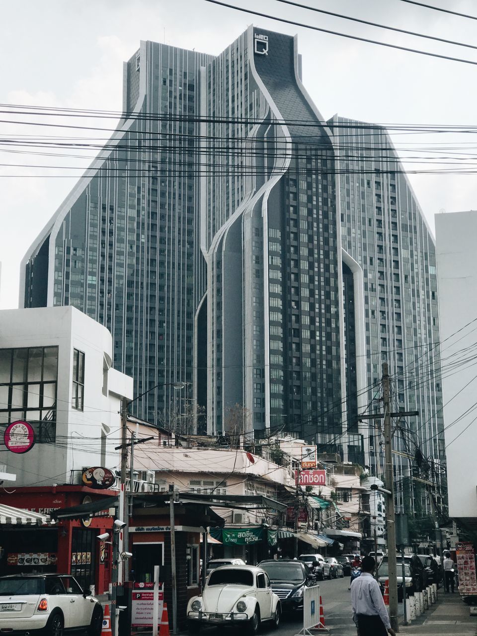 CARS ON STREET BY BUILDINGS AGAINST SKY