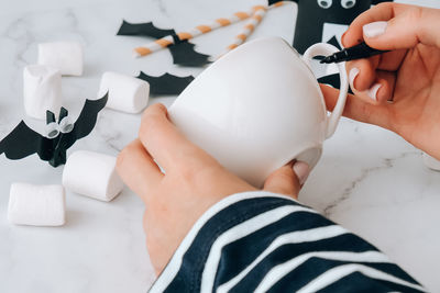 Cropped hands of woman holding toy