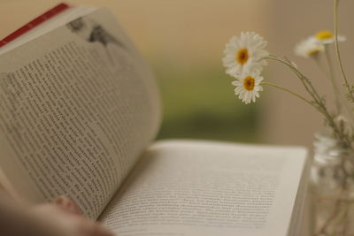 Close-up of hand on book