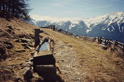 Scenic view of mountain range against cloudy sky