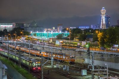 High angle view of illuminated train against sky at night