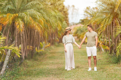 Portrait of smiling couple standing on field
