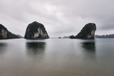 Rocks in sea against sky