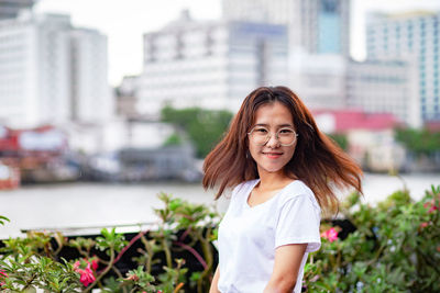 Portrait of smiling young woman standing outdoors